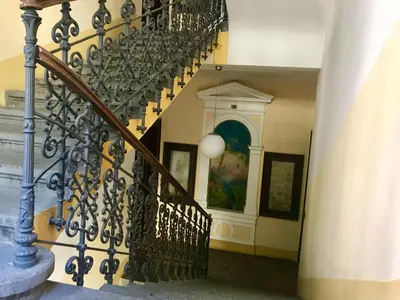a staircase with a wrought iron railing and a stair case at Spacious cozy apartments in centre in Prague