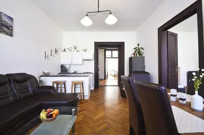 a living room with a couch and a table at Spacious cozy apartments in centre in Prague