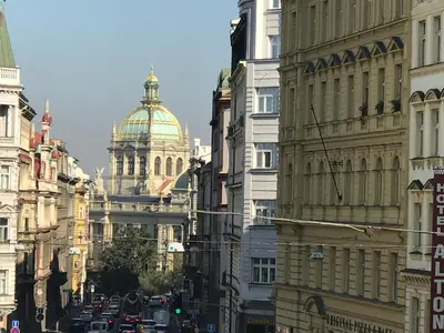 a city street with buildings with a cathedral in the background at Spacious cozy apartments in centre in Prague