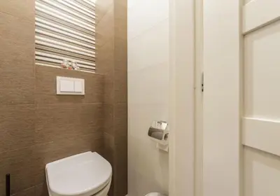 a small bathroom with a toilet and a window at Central Prague Crown Apartments in Prague