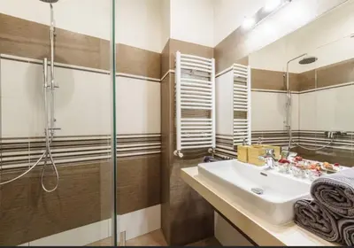 a bathroom with a sink and a shower at Central Prague Crown Apartments in Prague
