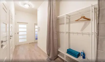 a walk in shower in a bathroom with white walls at Central Prague Crown Apartments in Prague