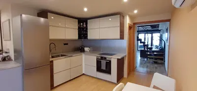 a kitchen with white appliances and a dining room at Rooftop Deluxe apartment in Prague
