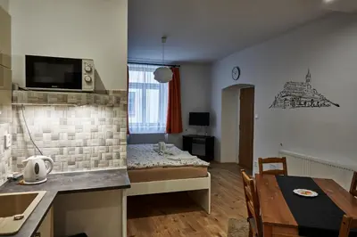 a small room with a bed and a dining table at Krejčovství in Mělník