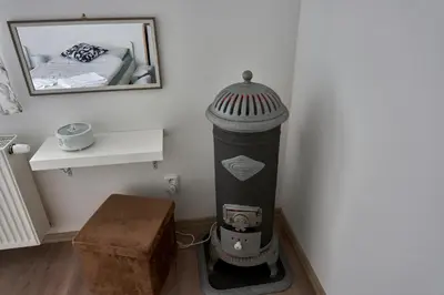 a room with a heater in the corner of a room at Krejčovství in Mělník