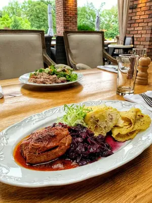 a table with two plates of food on it at Park Hotel Popovicky in Popovičky