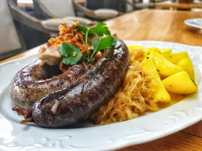 a plate of sausages and rice on a table at Park Hotel Popovicky in Popovičky