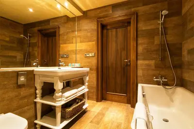 a bathroom with a sink and a tub at Park Hotel Popovicky in Popovičky