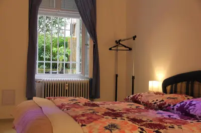 a bedroom with two beds in front of a window at Apartment Vltava Prague in Prague
