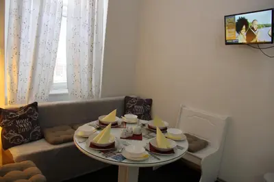 a living room with a table and a couch at Apartment Vltava Prague in Prague