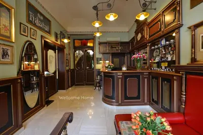 a bar in a pub with a red couch at Hotel Hastal Prague Old Town in Prague