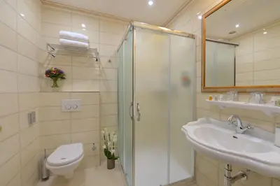 a bathroom with a shower and a toilet and a sink at Hotel Hastal Prague Old Town in Prague