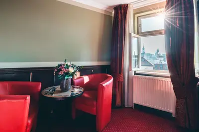a room with a table and a chair and a window at Hotel Hastal Prague Old Town in Prague