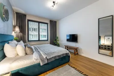 a bedroom with a bed and a large window at Apartment Invalidovna with FREE parking in Prague