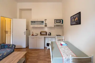 a small kitchen with a table in a small apartment at Downtown Apartments in Prague