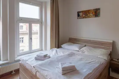 a bedroom with a bed with two towels on it at Downtown Apartments in Prague
