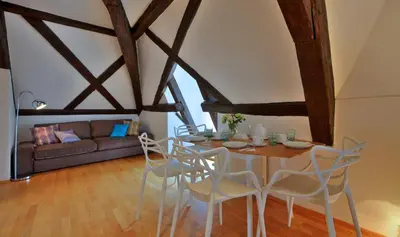 a living room with a table and chairs and a couch at Ericsson Palace in Prague