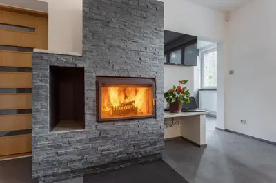 a brick fireplace with a fire in it at Villa Lhota in Lhota