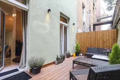 a patio with a bench and a fence at Ruterra Studio with Private Terrace in Prague
