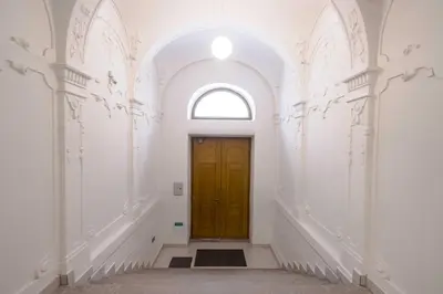 a hallway with a yellow door and an archway at Ruterra Studio with Private Terrace in Prague
