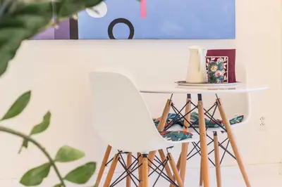 a white chair sitting next to a table at Ruterra Studio with Private Terrace in Prague