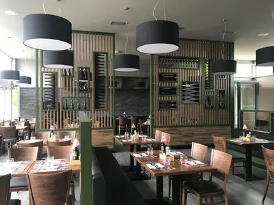 a restaurant with wooden tables and chairs and lights at Exclusive Pension Vista Mlada Boleslav in Bradlec