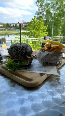 a hamburger and french fries on a table at Exclusive Pension Vista Mlada Boleslav in Bradlec
