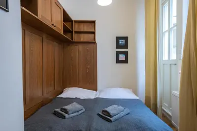 a bedroom with a bed with two towels on it at Apartman Carolinum in Prague