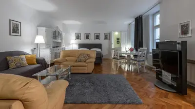 a living room with a couch and a table at Apartman Carolinum in Prague