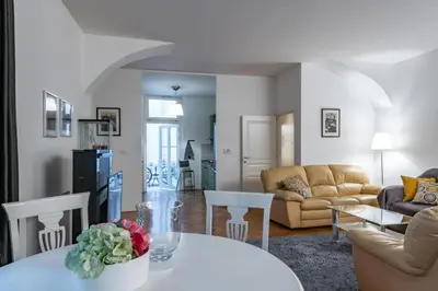 a living room with a white table and chairs at Apartman Carolinum in Prague