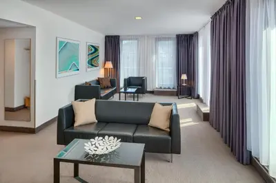 a living room with a couch and a table at Hermitage Hotel Prague in Prague