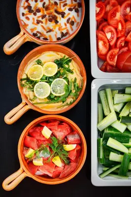 a group of four bowls of food with vegetables at Hermitage Hotel Prague in Prague