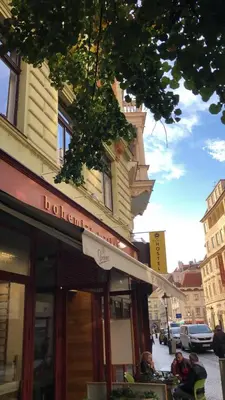a building with an awning on the side of a street at Best Spot Hostel in Prague