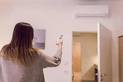 a woman holding a cell phone in front of a mirror at Kings Residence in Prague