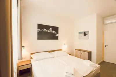 a bedroom with a white bed in a room at Kings Residence in Prague