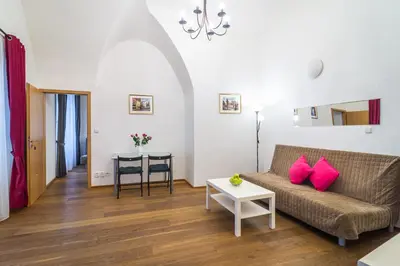 a living room with a couch and a table at Royal Road Residence II in Prague