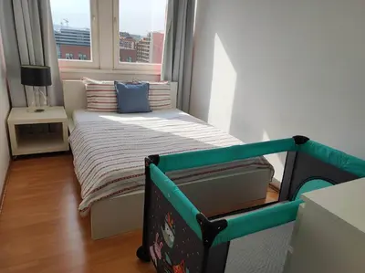 a small bedroom with a bed and a window at Golden Family Apartments in Prague