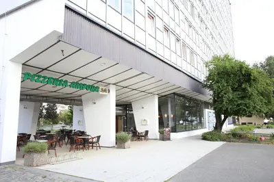 a restaurant with tables and chairs in front of a building at Golden Family Apartments in Prague