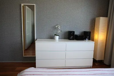 a white dresser with two speakers and a mirror at Golden Family Apartments in Prague