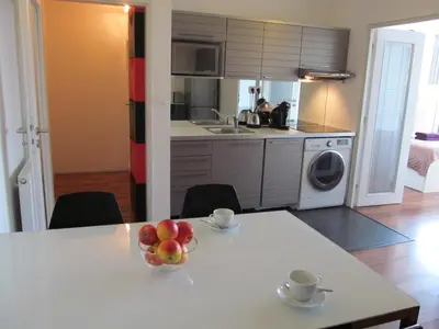 a kitchen with a table with a bowl of fruit on it at Golden Family Apartments in Prague