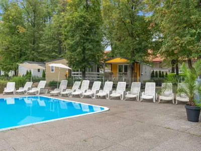 a group of chairs sitting next to a swimming pool at Holiday Home Sunset Terrace by Interhome in Prague