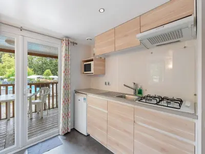 a kitchen with wooden cabinets and a balcony at Holiday Home Sunset Terrace by Interhome in Prague