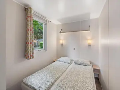 two beds in a room with a window at Holiday Home Sunset Terrace by Interhome in Prague