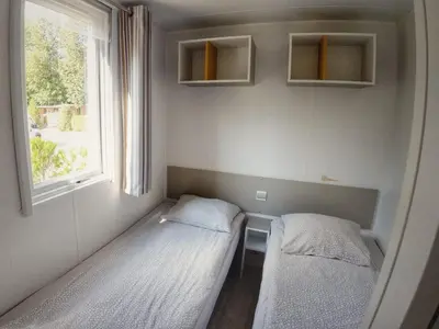 a small room with two beds and a window at Holiday Home Hawaii Style by Interhome in Prague