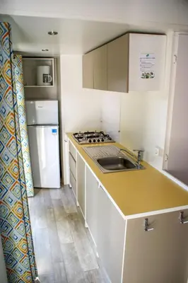a small kitchen with a sink and a refrigerator at Holiday Home Hawaii Style by Interhome in Prague