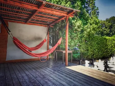 a hammock on the deck of a house at Holiday Home Hawaii Style by Interhome in Prague