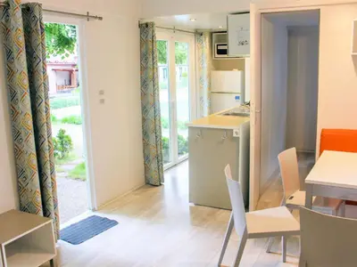 a kitchen and dining room with a table and chairs at Holiday Home Hawaii Style by Interhome in Prague