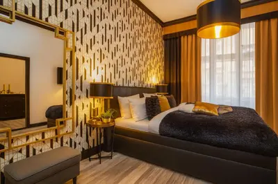 a bedroom with a bed and a mirror at Golden Prague Rooms in Prague