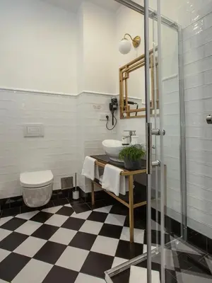 a bathroom with a sink and a toilet at Golden Prague Rooms in Prague