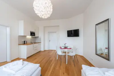 a kitchen and dining room with a table and chairs at Residence Tesnov Apartment in Prague